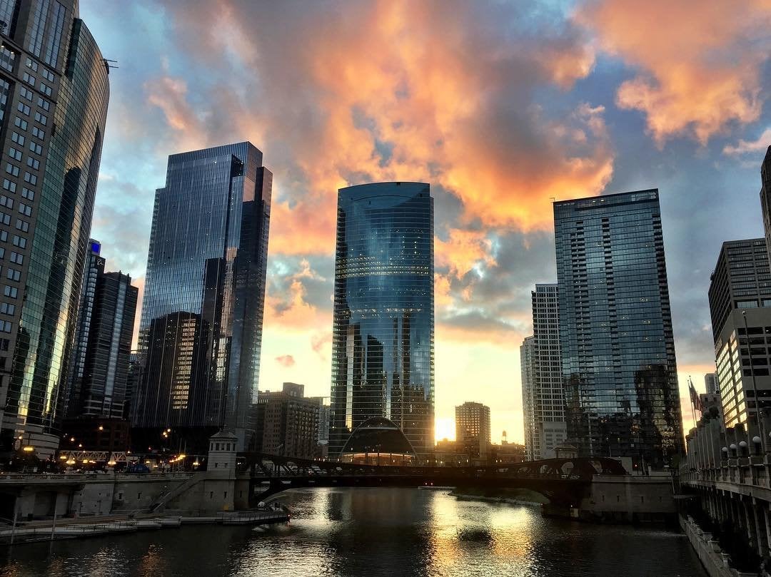 Chicago River during sunset with vibrant colors reflecting on the water